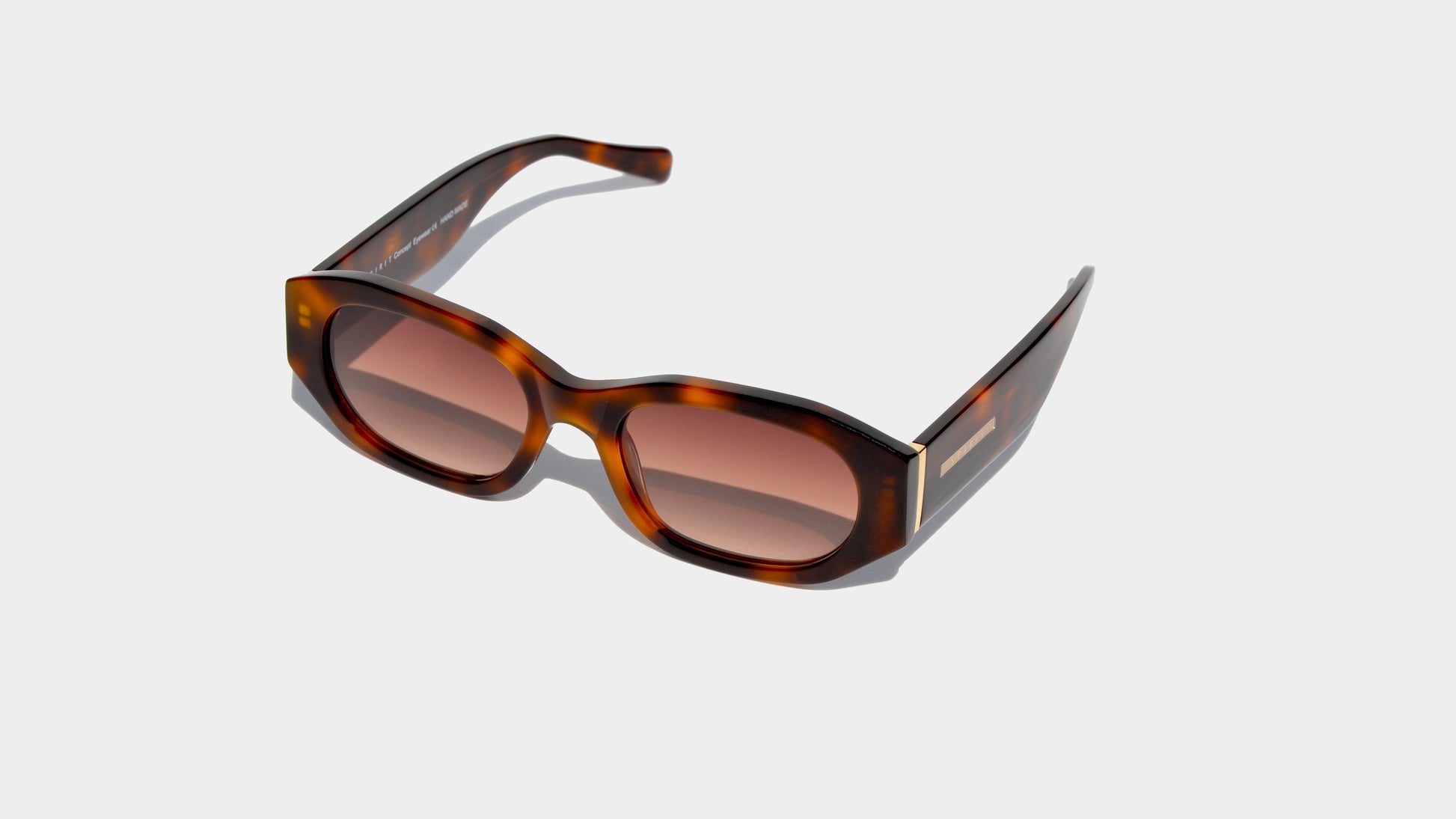 Angled front view of havana brown patten rectangle frame sunglasses with narrow amber lenses