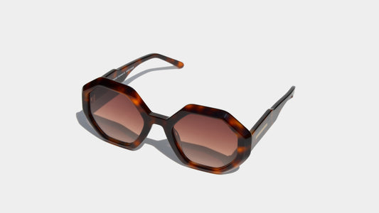 Angled front view of havana brown patten geometric frame sunglasses with amber round lenses