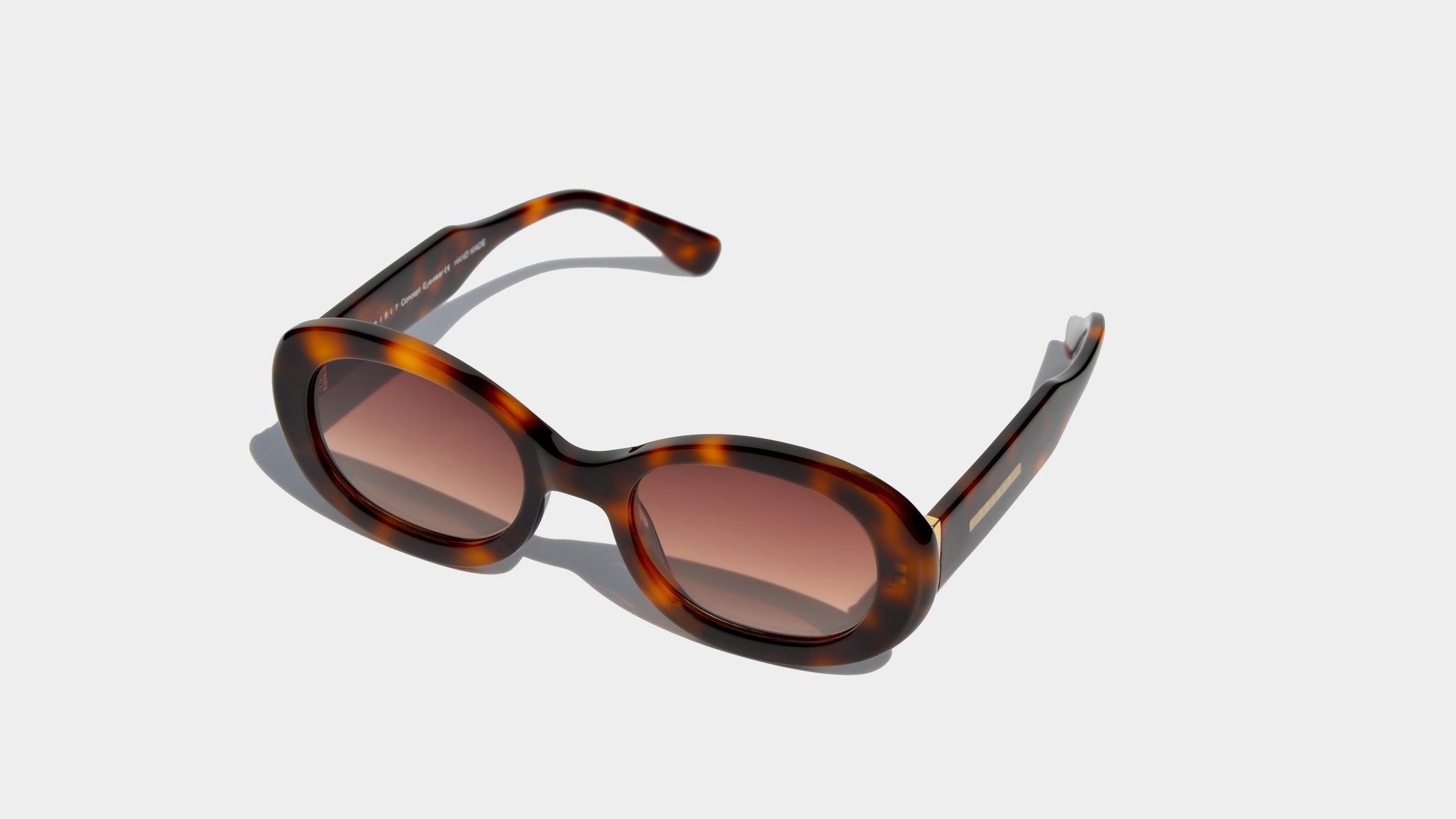 Angled front view of havana brown patten oval frame sunglasses with amber oval lenses