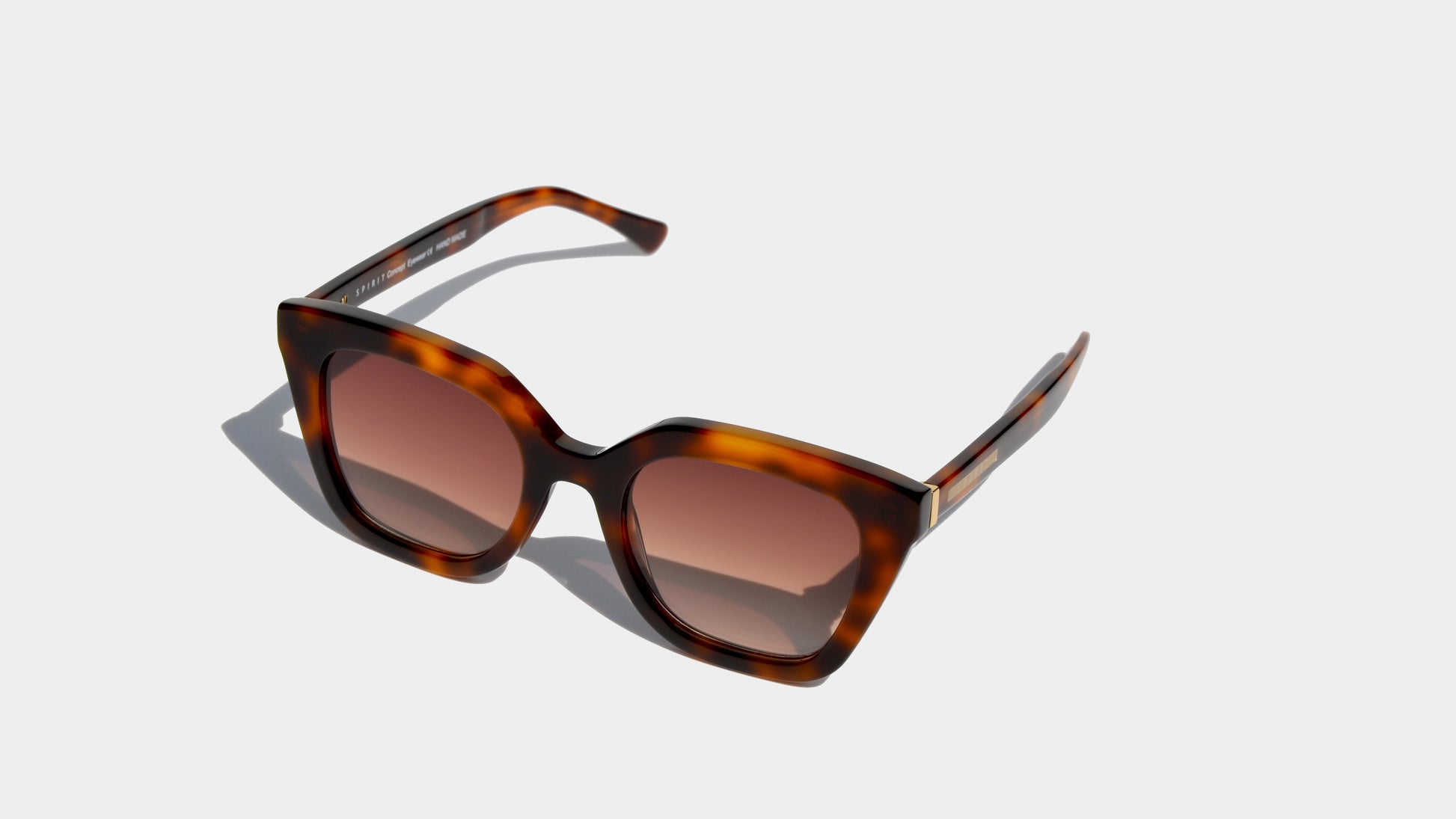 Angled front view of havana brown patten sharp angular cat eye frame sunglasses with amber square lenses