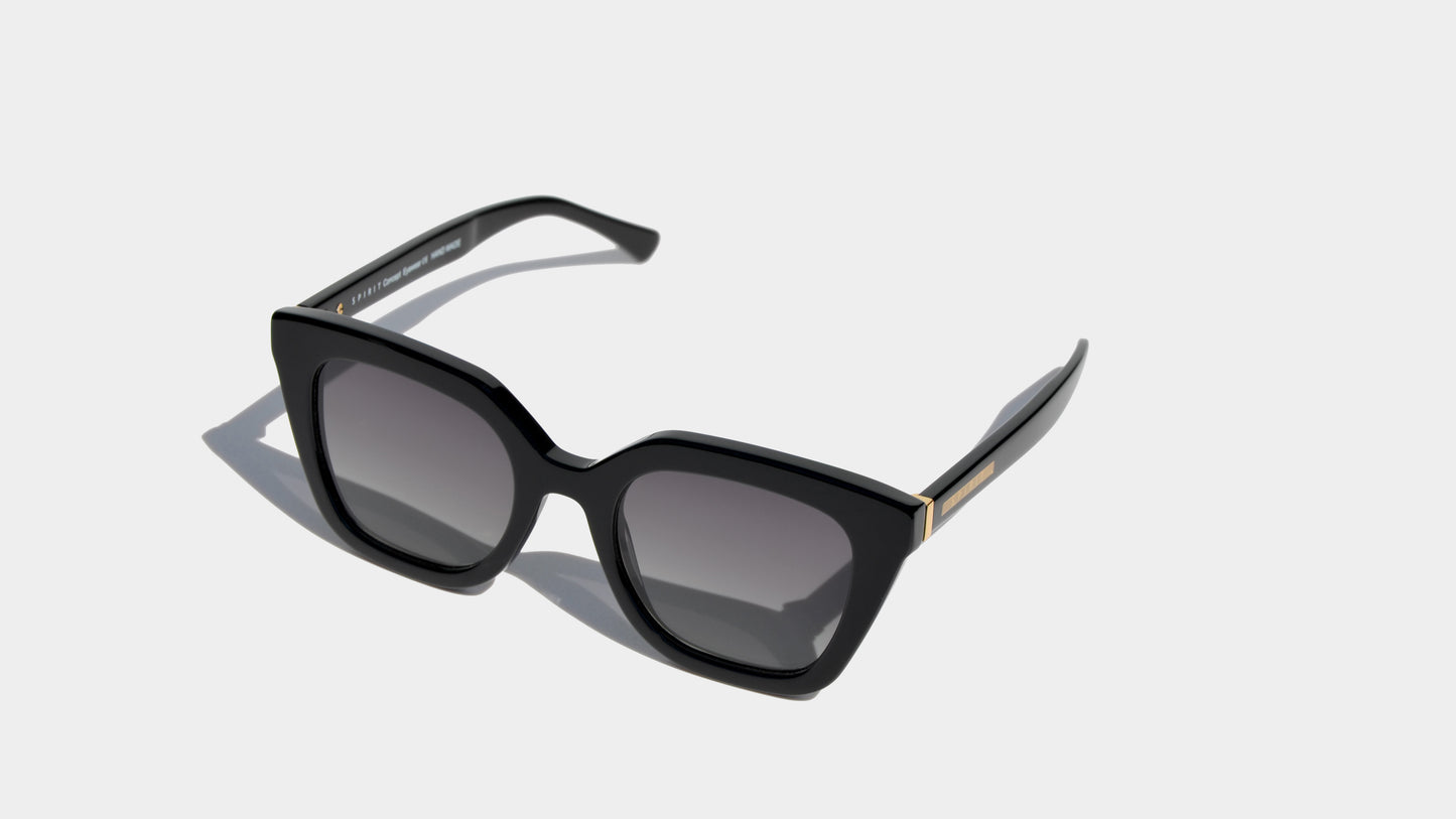 Angled front view of black sharp angular cat eye frame sunglasses with grey square lenses