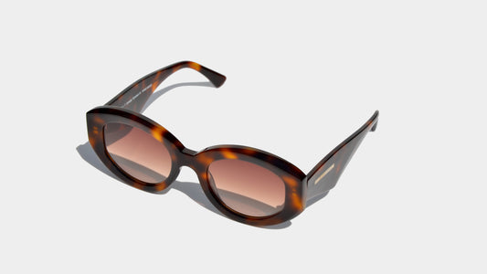 Angled front view of havana brown patten rectangle frame sunglasses with amber oval lenses