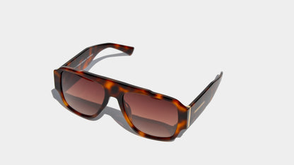 Angled front view of havana brown patten bold oversized shield frame sunglasses with amber square lenses