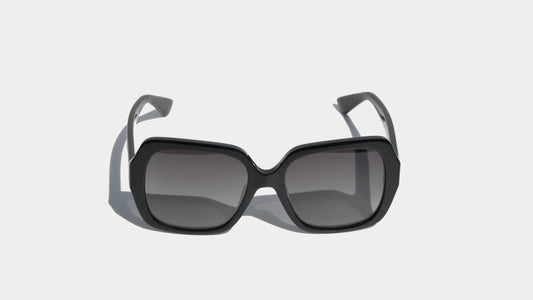 Front view of Bailey shiny black oversized butterfly sunglasses featuring gradient gray lenses and stylish frame design for an elegant look.