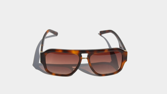 Front view of Charlie Havana brown eyewear with a bold navigator design, gradient amber lenses, and a contemporary flair.