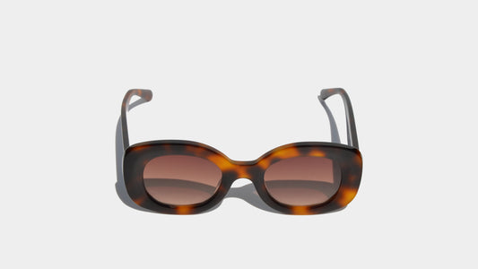 Front view of Havana brown Jacky sunglasses with oval cat-eye frames and gradient amber nylon lenses, offering a stylish and timeless aesthetic.