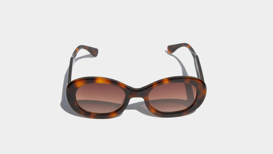 Front view of Havana brown eyewear with oval frames and gradient amber lenses, blending classic design with modern appeal.