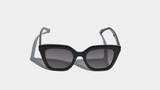 Front view of Merhoki Robin Eyewear in shiny black, showcasing sleek square frames with a contemporary finish.